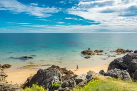 Panoramic shot of a rocky white beach on thin clouds background A panoramic shot of a rocky white beach on thin clouds background